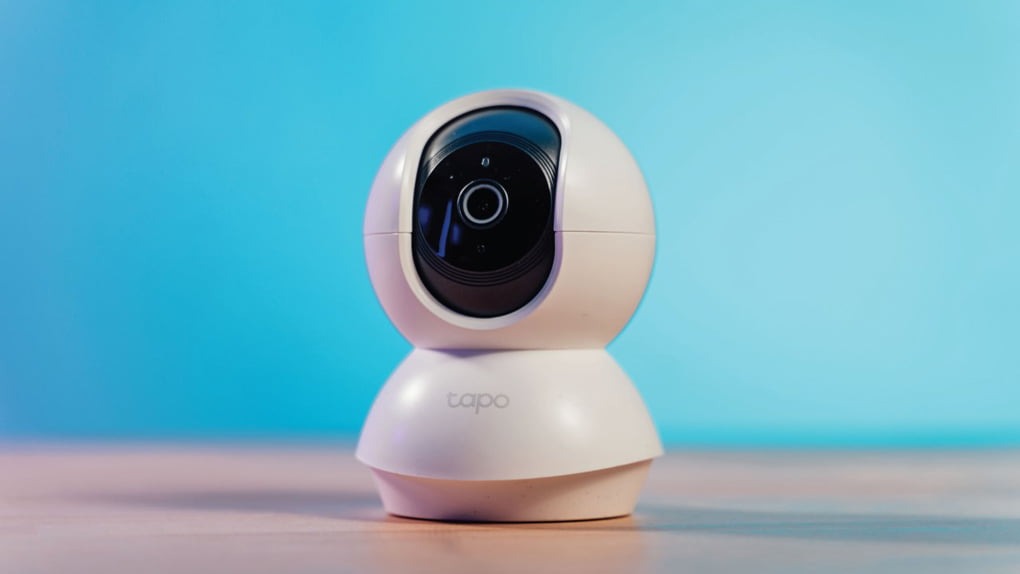White security camera on blue background